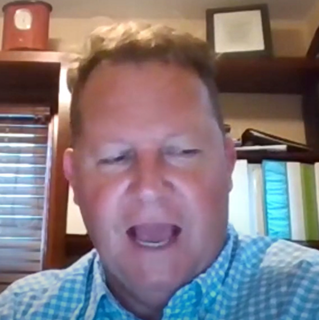 Chris Ryan speaking on a video call from a home office